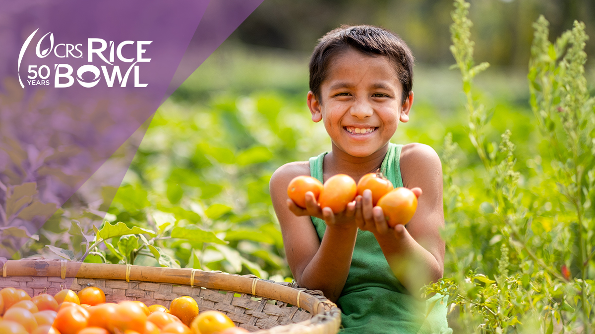 boy holding tomatoes