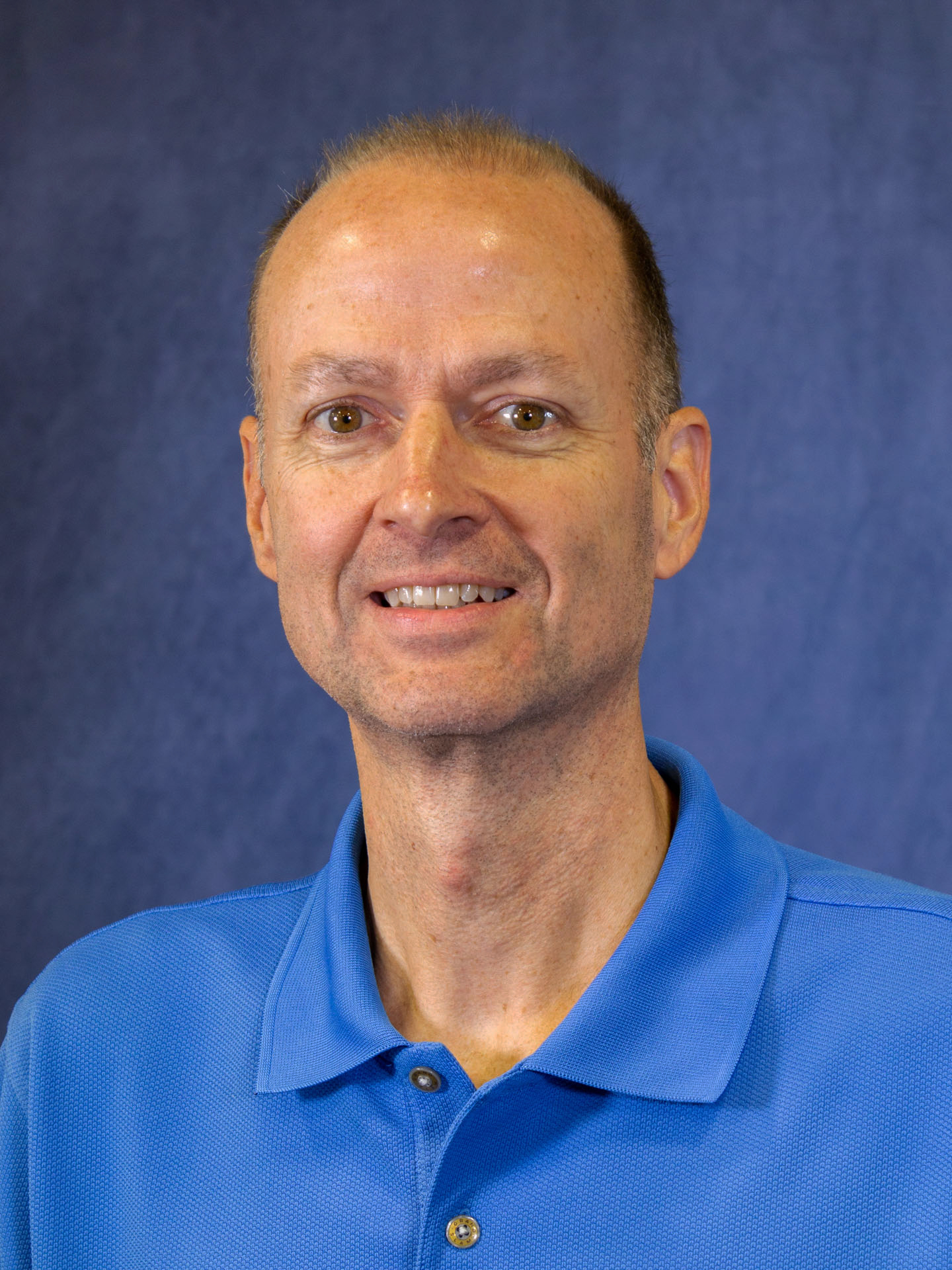 man in blue polo headshot