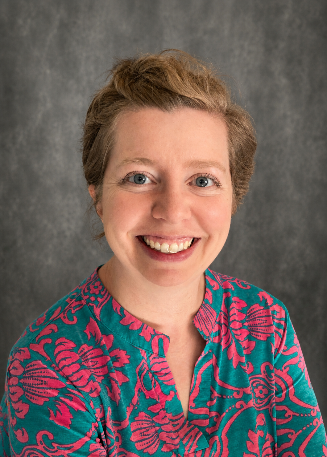 woman wearing teal and pink patterned shirt
