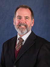 man with beard in a suit and tie