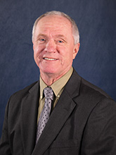 gray haired man in suit