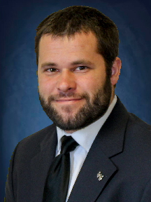 young man with beard and suit headshot