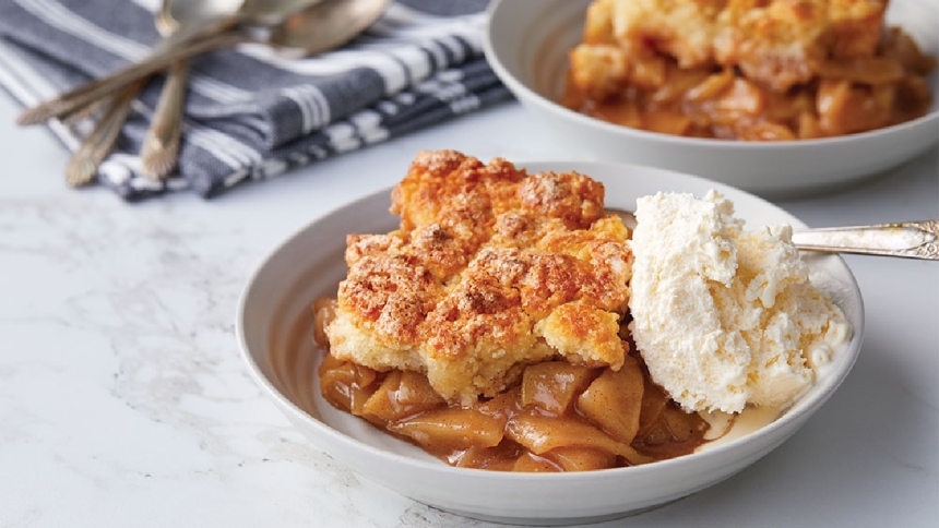 bowl of apple cobbler with vanilla ice cream