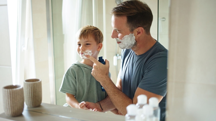 dad teaching son how to shave