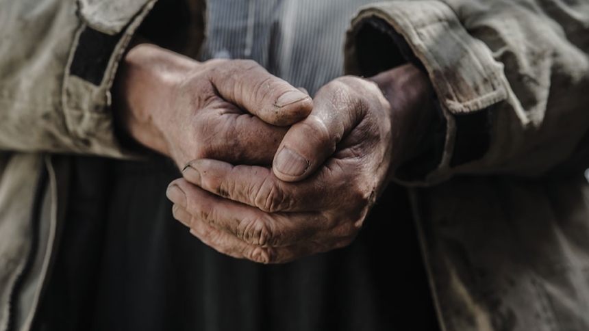 older man's clasped hands