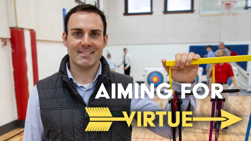 man standing in front of archery equipment