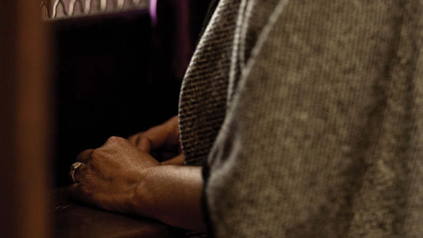 woman sitting in confessional booth