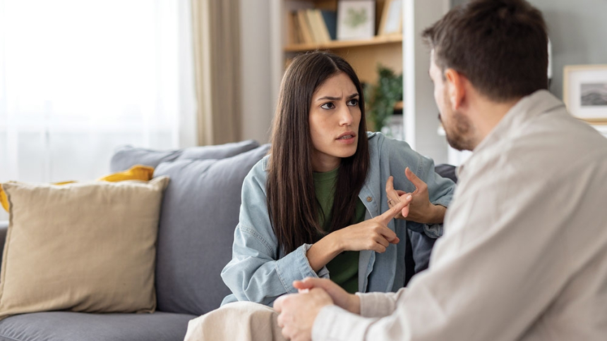 man and wife on couch arguing