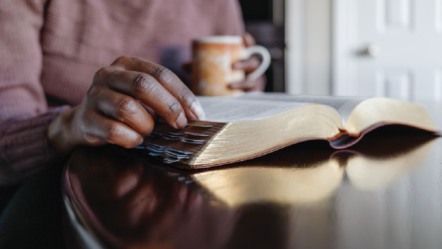 Reading bible with coffee