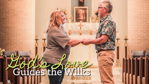 couple holding hands in church